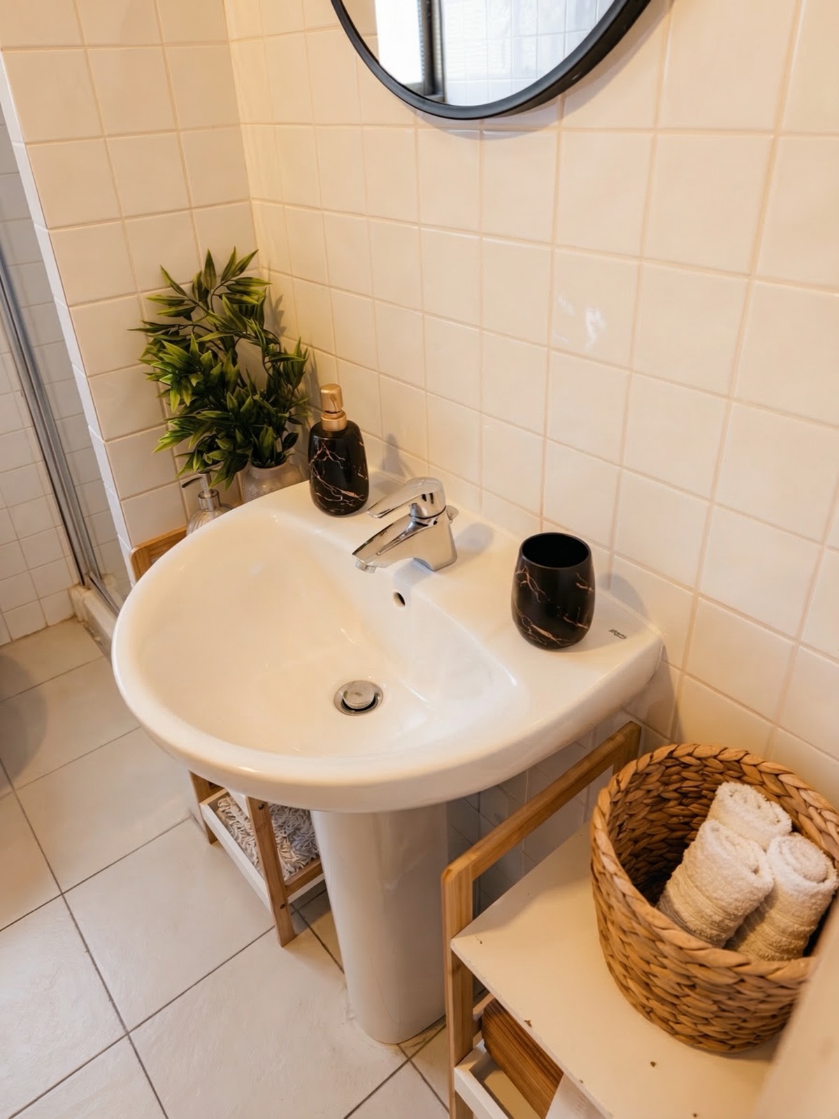 Bathroom sink with plants and marble accessories