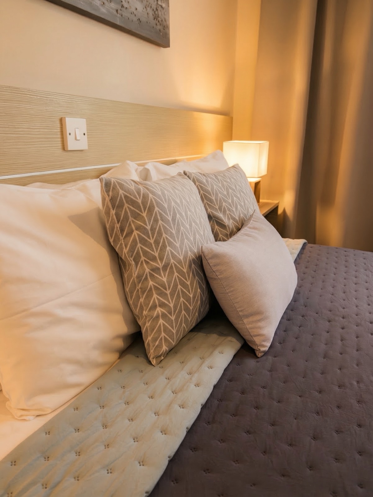Luxury pillows and warm bedside lighting