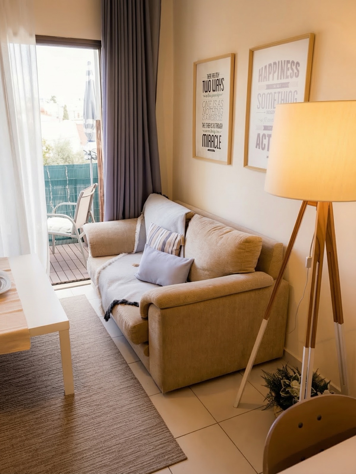 Cozy sofa area with balcony door and motivational art